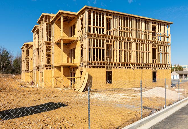 a temporary chain link fence winding around a construction site, outlining the project's progress in Blanchard, OK